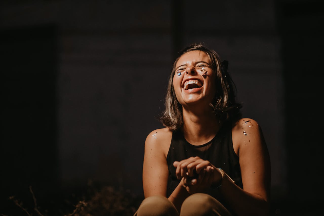 Woman laughing with eyes closed